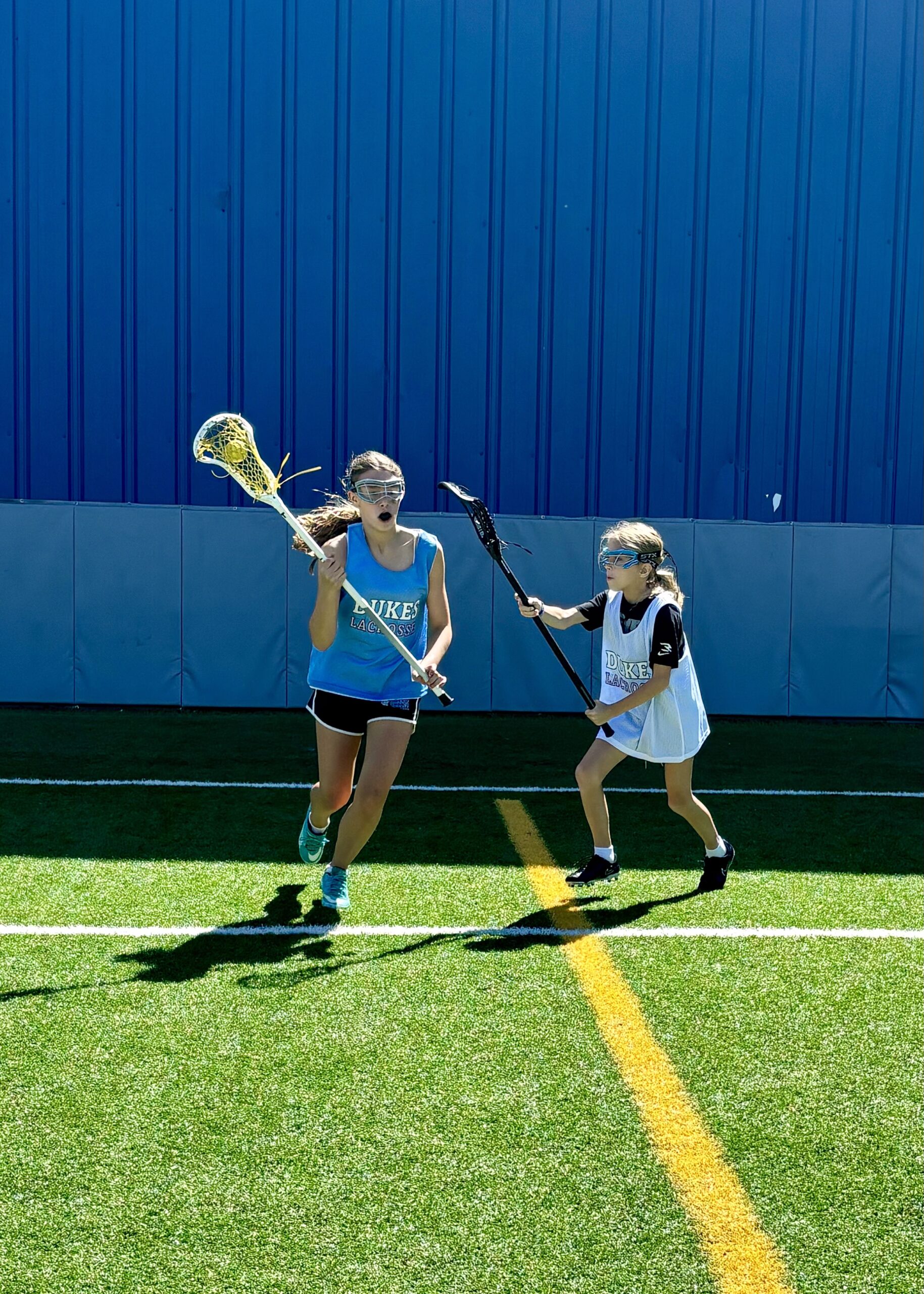 Competitive girls lacrosse game action